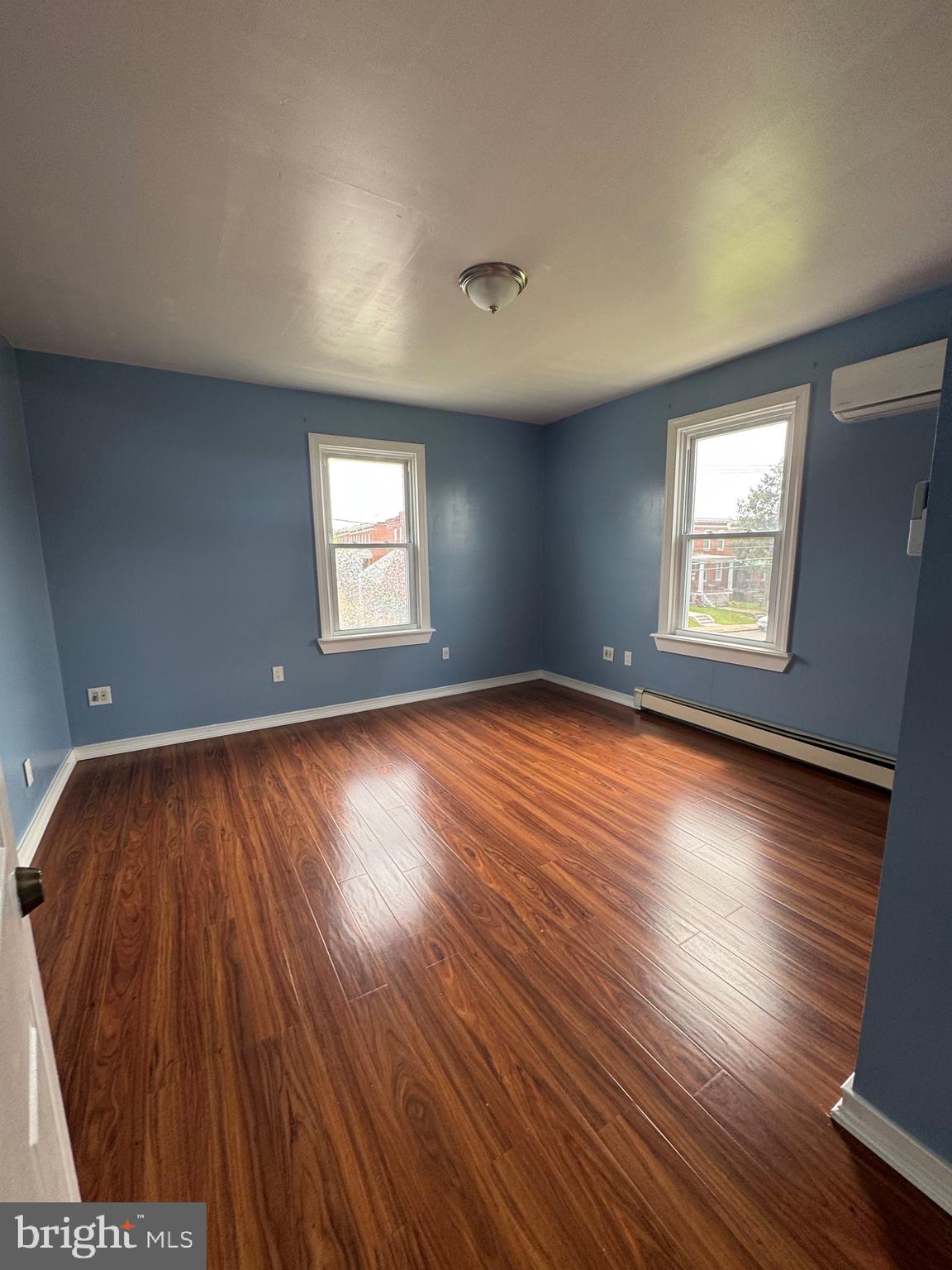 3706 Old York Road, Unit 2 Baltimore, MD 21218 - Photo 15 of 17 a view of an empty room with wooden floor and window