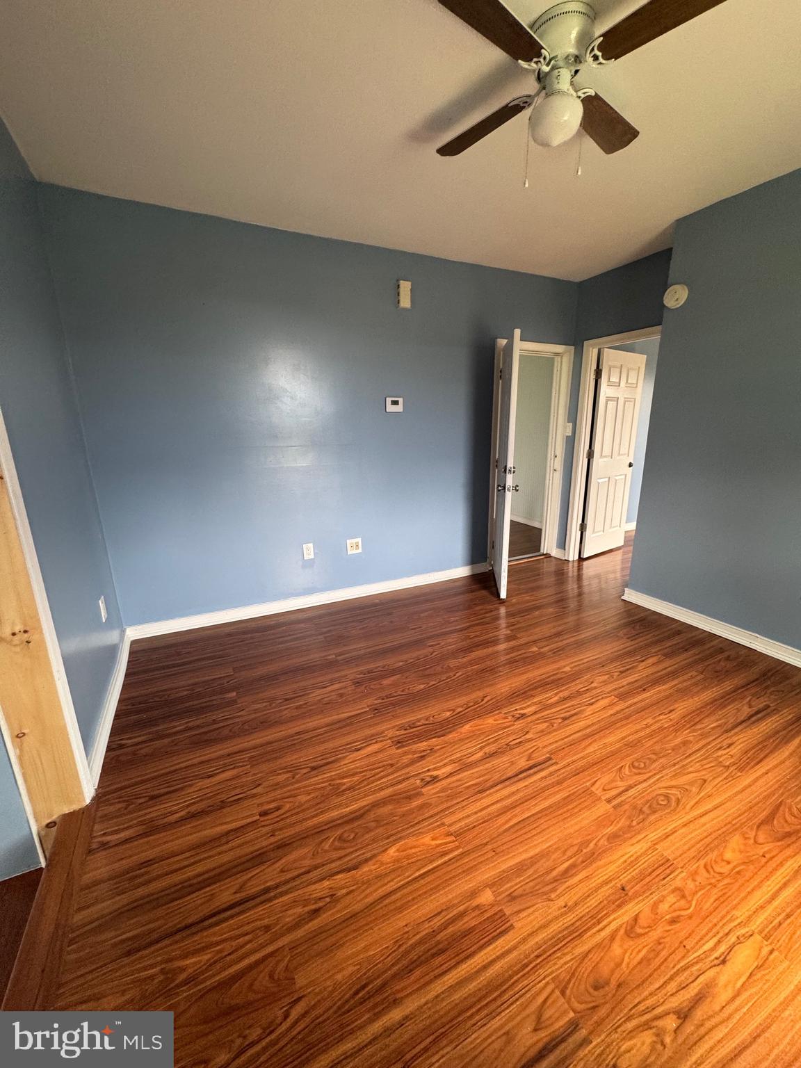3706 Old York Road, Unit 2 Baltimore, MD 21218 - Photo 6 of 17 a view of an empty room with wooden floor and a window