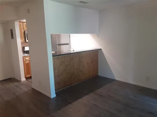 an empty room with wooden floor