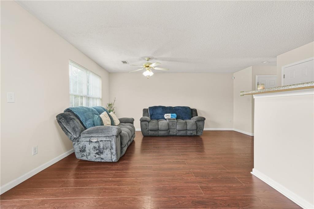 7104 Georges Way Morrow, GA 30260 - Photo 12 of 39 a living room with furniture and a chandelier