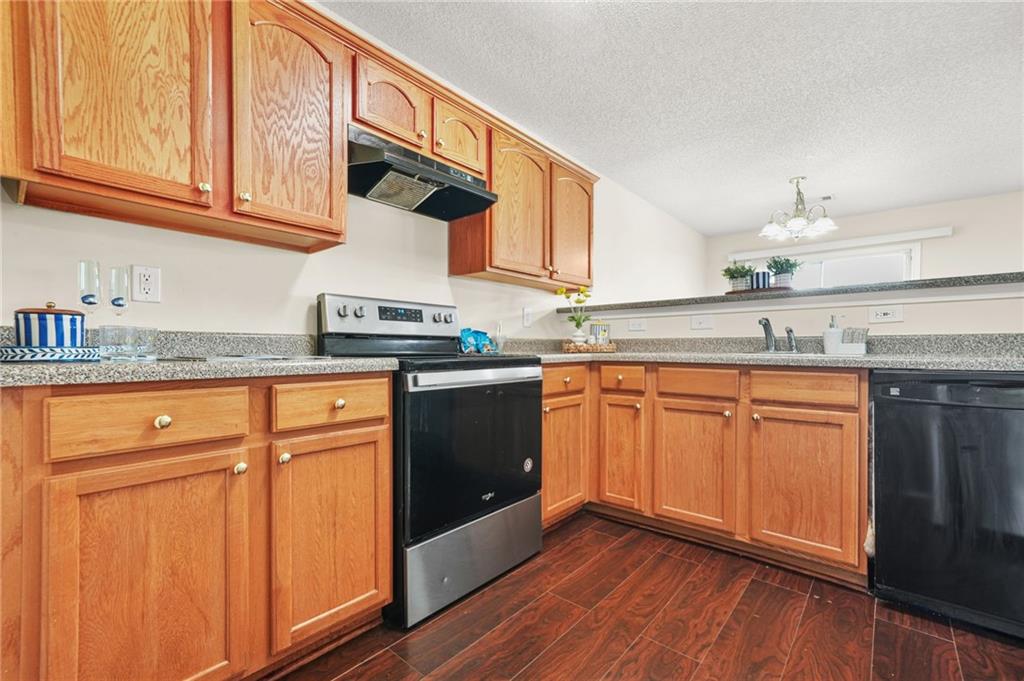7104 Georges Way Morrow, GA 30260 - Photo 14 of 39 a kitchen with granite countertop stainless steel appliances a sink and cabinets