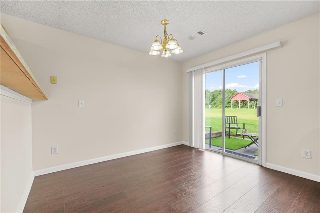 7104 Georges Way Morrow, GA 30260 - Photo 16 of 39 a view of an empty room with wooden floor and a window