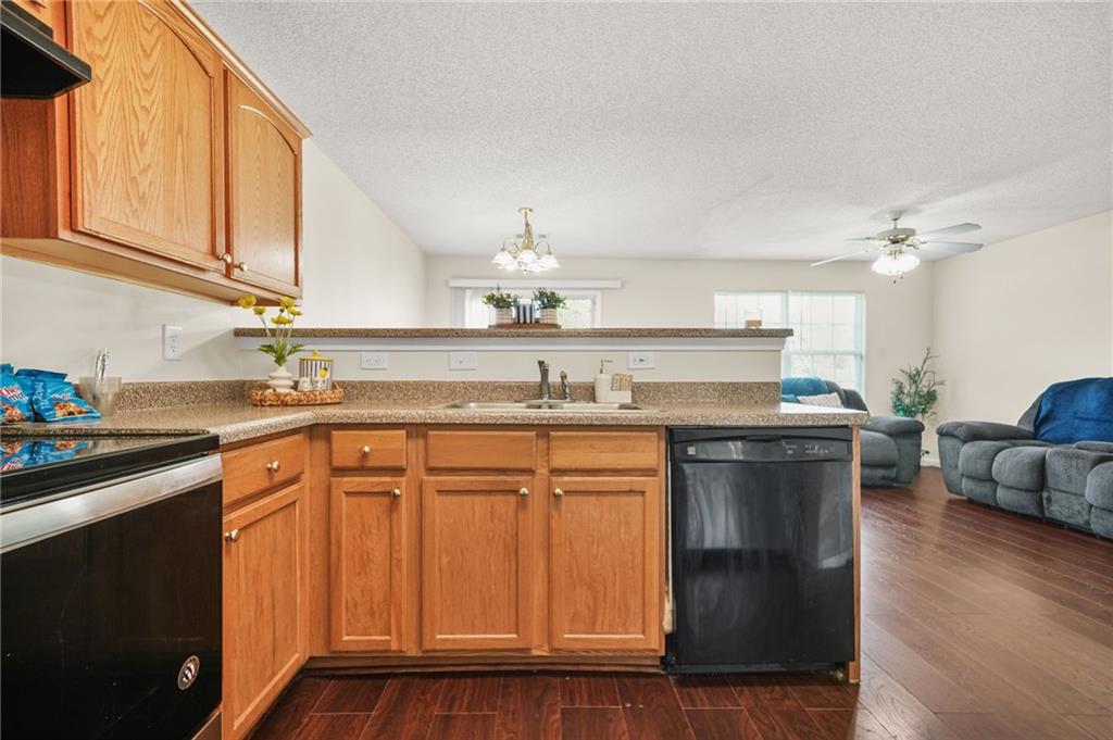 7104 Georges Way Morrow, GA 30260 - Photo 18 of 39 a kitchen with stainless steel appliances granite countertop a sink and cabinets