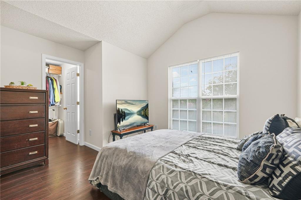 7104 Georges Way Morrow, GA 30260 - Photo 21 of 39 a bedroom with a bed and a flat tv screen on a dresser