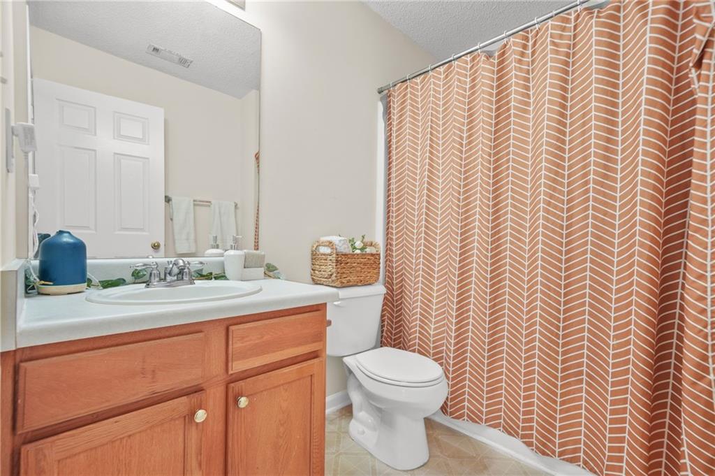 7104 Georges Way Morrow, GA 30260 - Photo 24 of 39 a bathroom with a granite countertop sink and a mirror