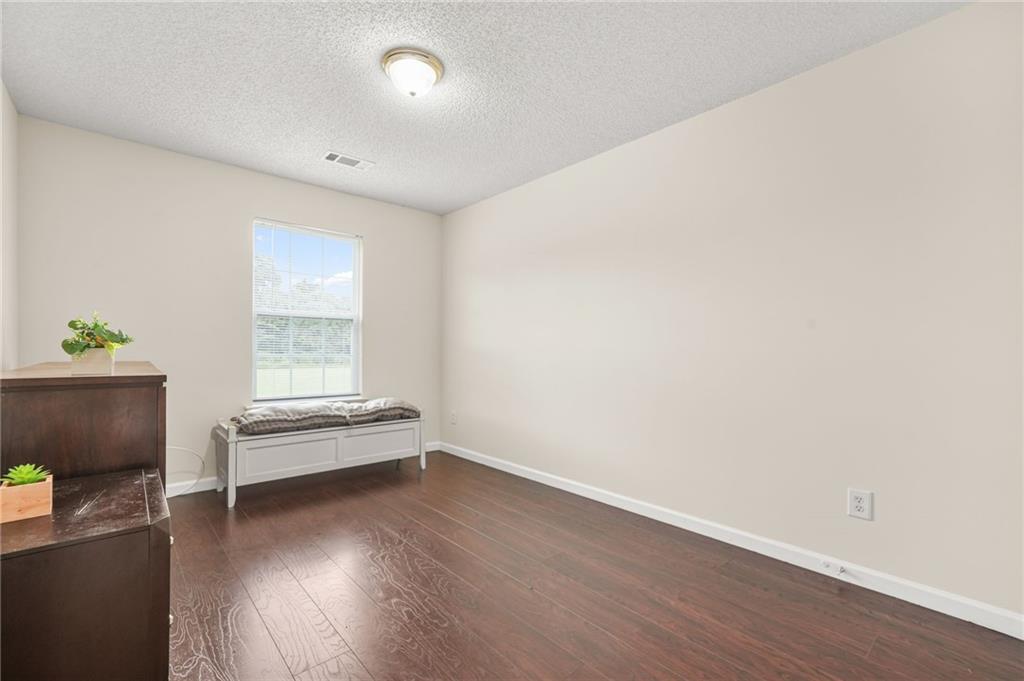 7104 Georges Way Morrow, GA 30260 - Photo 25 of 39 an empty room with wooden floor and windows