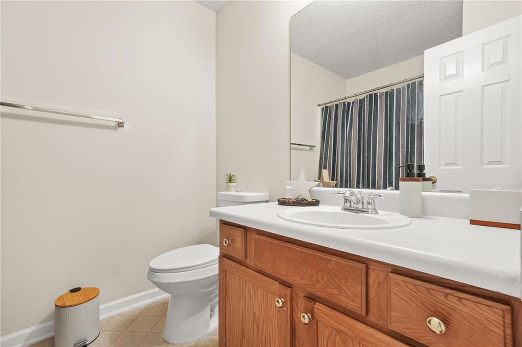 7104 Georges Way Morrow, GA 30260 - Photo 27 of 39 a bathroom with a sink a toilet and a large mirror