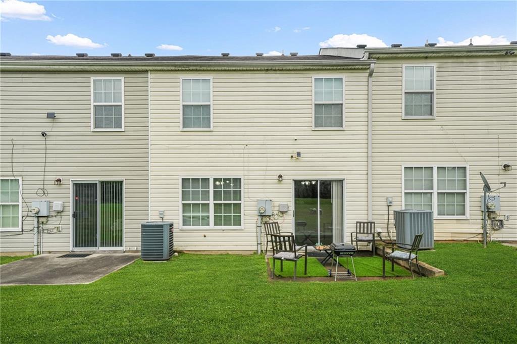 7104 Georges Way Morrow, GA 30260 - Photo 34 of 39 a front view of a house with a garden and chairs