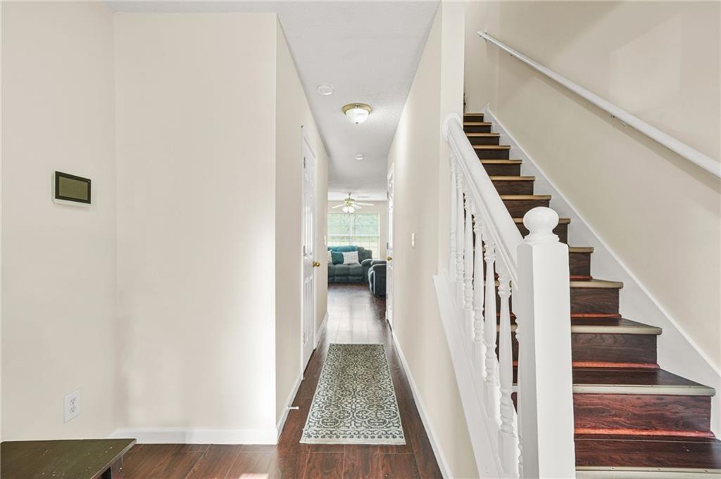 7104 Georges Way Morrow, GA 30260 - Photo 8 of 39 a view of a hallway with wooden floor and staircase