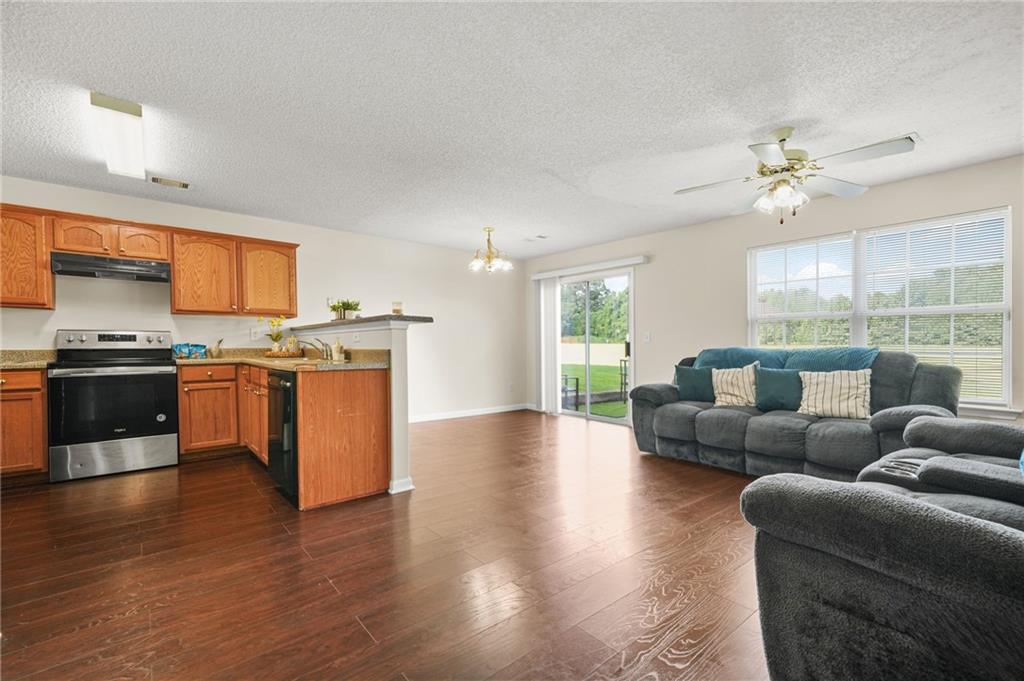 7104 Georges Way Morrow, GA 30260 - Photo 9 of 39 a living room with furniture wooden floor and a kitchen view