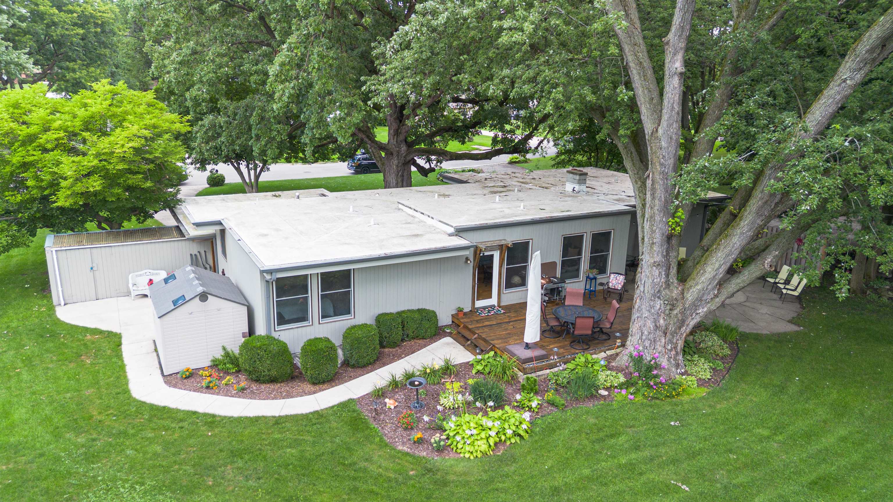 4609 Brookview Road Rockford, IL 61107 - Photo 34 of 44 a front view of a house with a garden and porch
