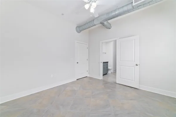 a bathroom with a granite countertop toilet sink and mirror