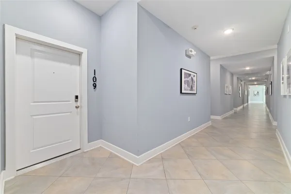 a kitchen with kitchen island a counter top space stainless steel appliances and a window