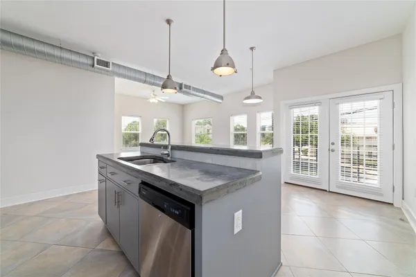a kitchen with a stove a sink and a window