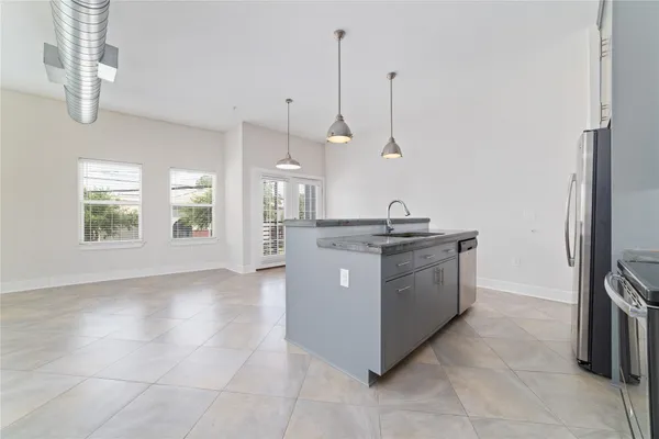 a kitchen with kitchen island a counter top space appliances and a cabinets