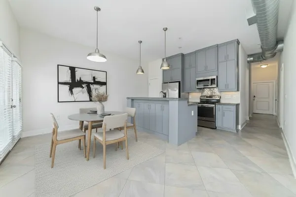 a kitchen with kitchen island white cabinets and window