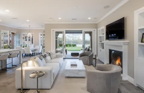 a living room with furniture a flat screen tv and a fireplace
