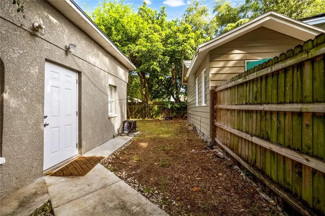 a view of a house with wooden fence