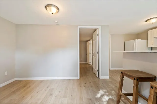 an empty room with wooden floor and a window