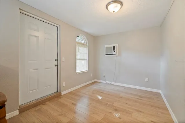 an empty room with windows and closet