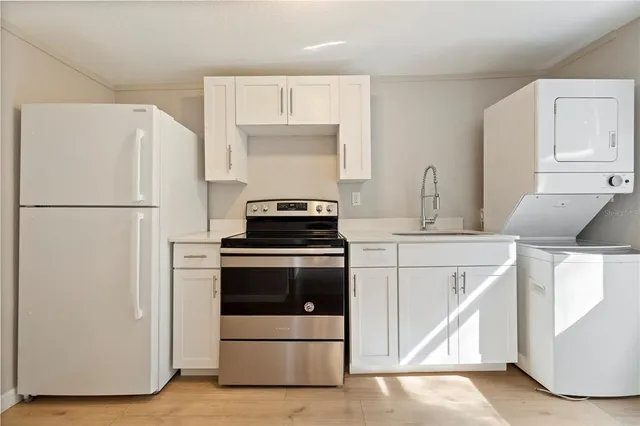 a kitchen with cabinets and white appliances