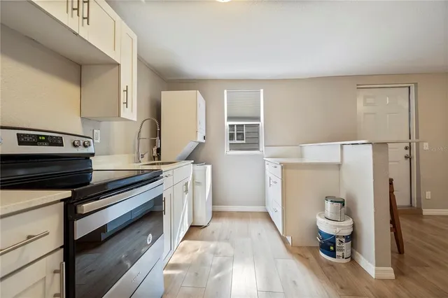 a kitchen with a stove and a refrigerator