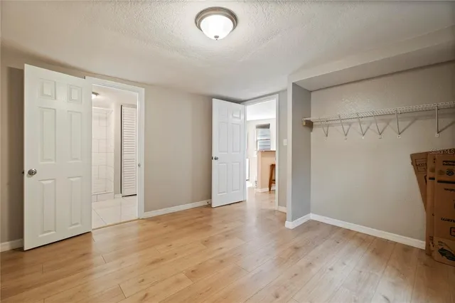 a view of a room with wooden floor and a window
