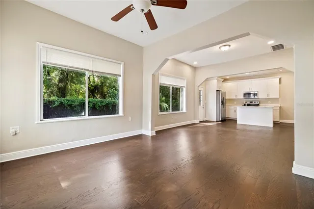 a view of a livingroom with furniture wooden floor and windows