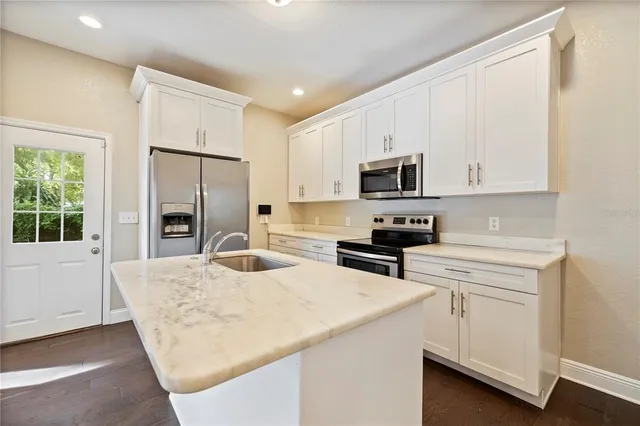 a kitchen with a sink stove and refrigerator