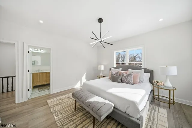 a bedroom with a bed and a chandelier