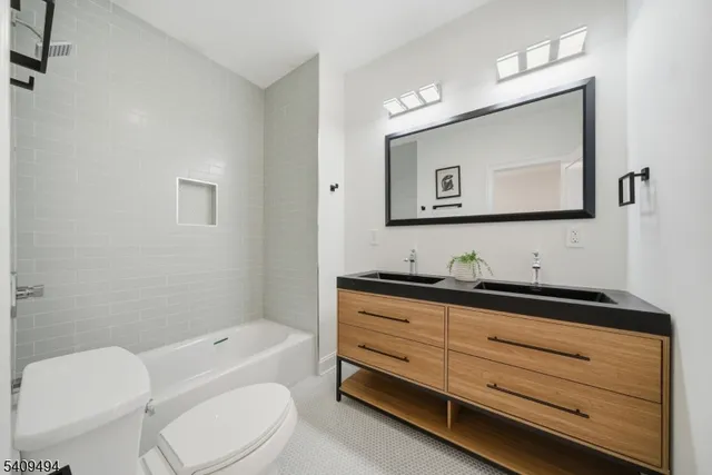 a bathroom with a toilet a sink and mirror