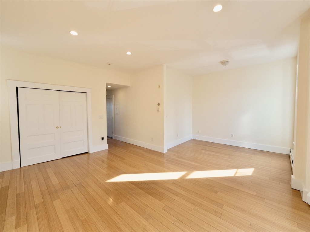 27 Fort Avenue, Unit 2 Boston, MA 02119 - Photo 2 of 7 a view of empty room with wooden floor