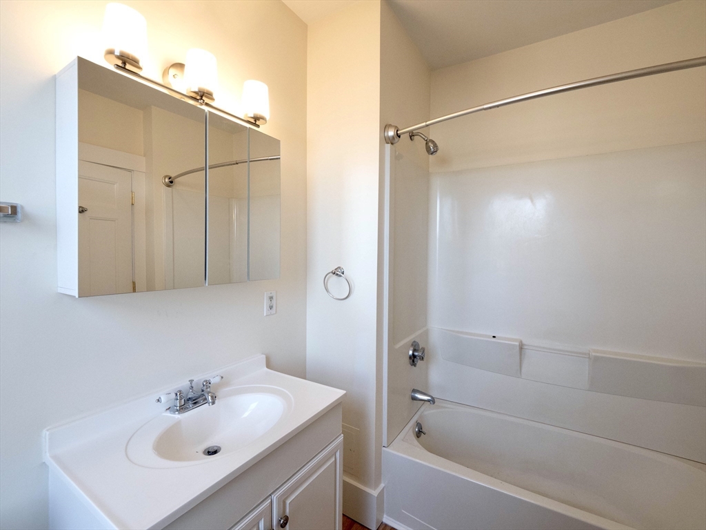 27 Fort Avenue, Unit 2 Boston, MA 02119 - Photo 5 of 7 a bathroom with a sink and shower