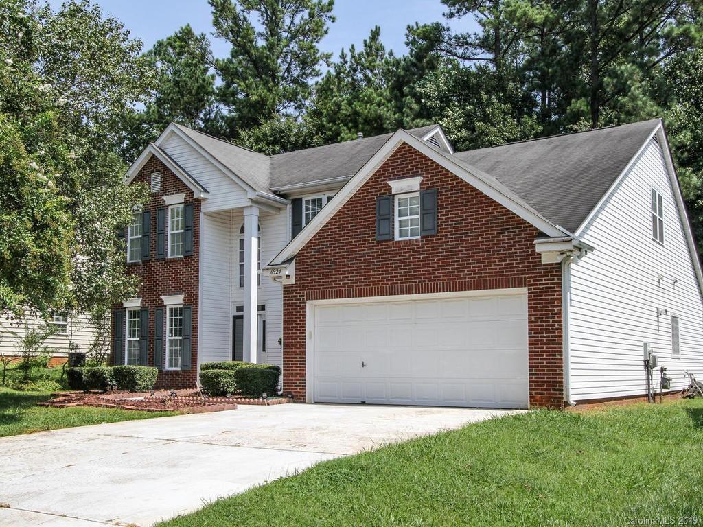 6924 Reedy Creek Road Charlotte, NC 28215 - Photo 2 of 47 a front view of house with yard and trees all around