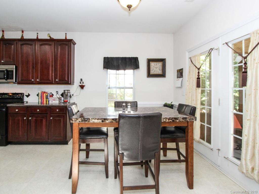 6924 Reedy Creek Road Charlotte, NC 28215 - Photo 18 of 47 a view of a workspace with furniture and a kitchen