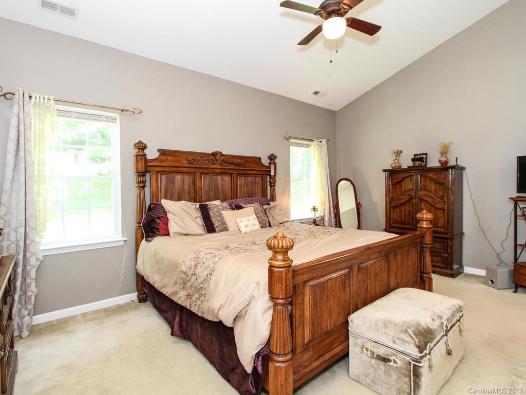 6924 Reedy Creek Road Charlotte, NC 28215 - Photo 22 of 47 a bedroom with a bed and a chandelier