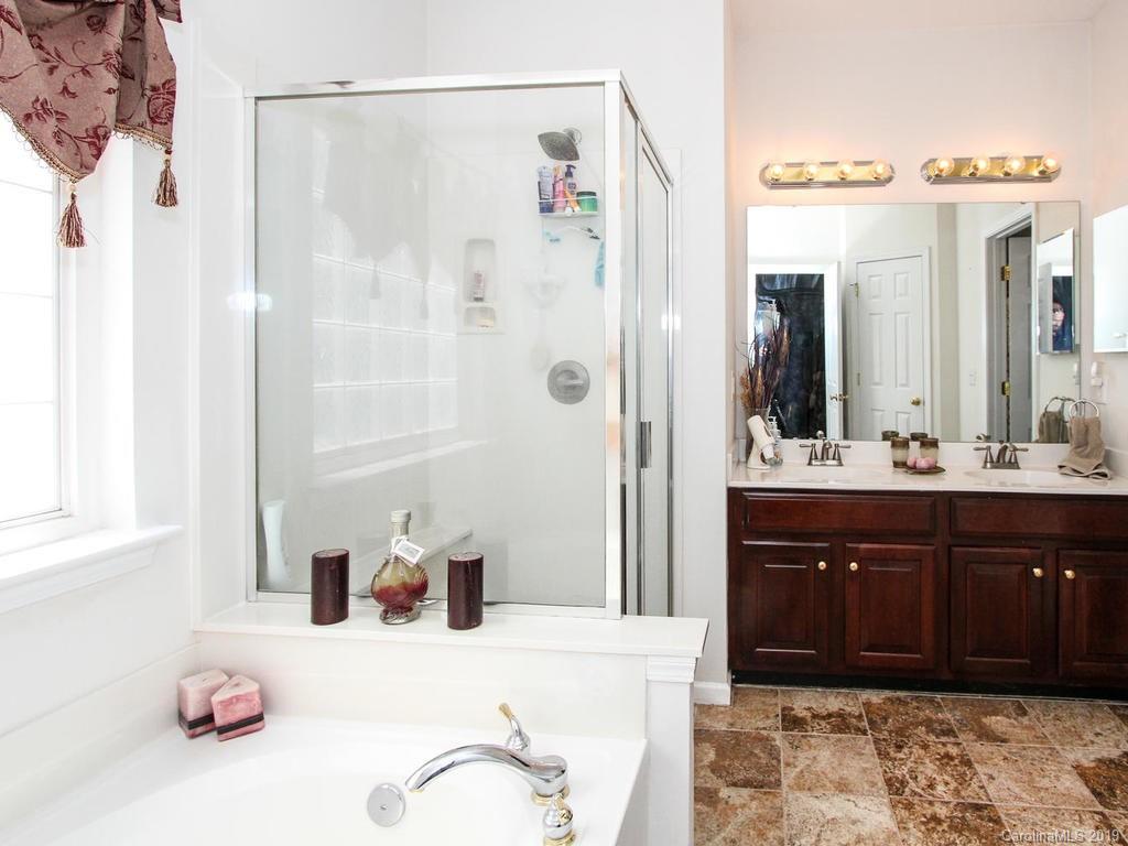 6924 Reedy Creek Road Charlotte, NC 28215 - Photo 23 of 47 a bathroom with a sink vanity and a mirror