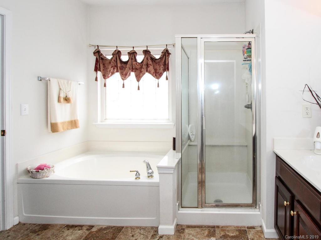 6924 Reedy Creek Road Charlotte, NC 28215 - Photo 25 of 47 a bathroom with a bathtub a shower and a sink