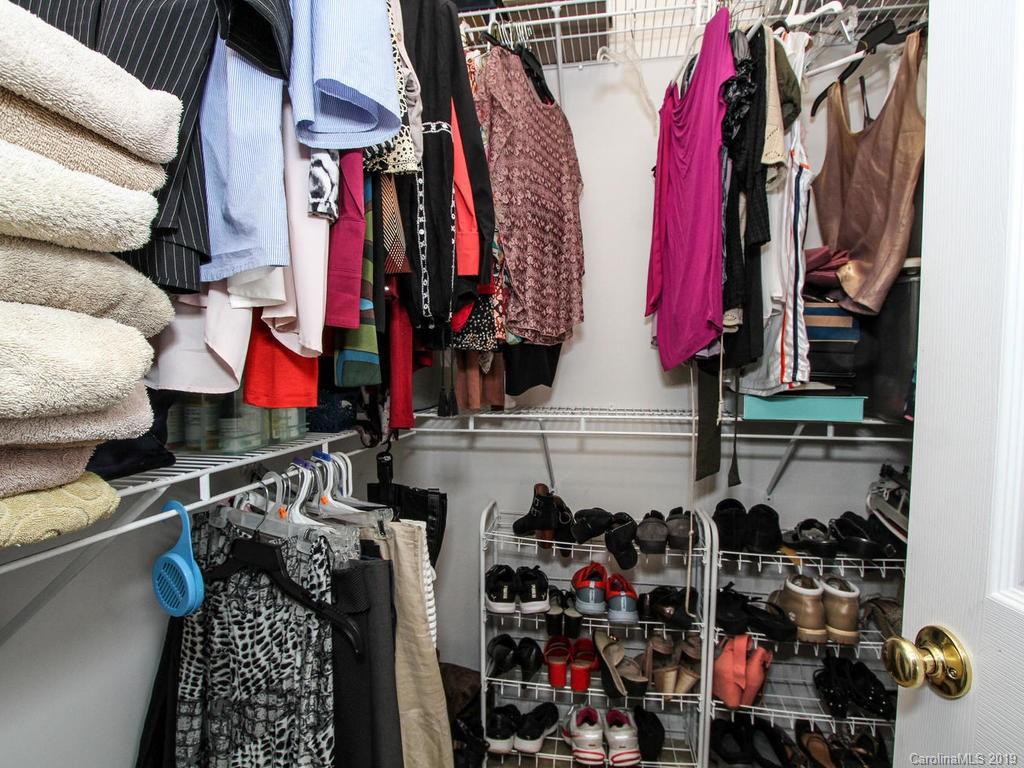 6924 Reedy Creek Road Charlotte, NC 28215 - Photo 27 of 47 a view of walk in closet with clothes and shoes