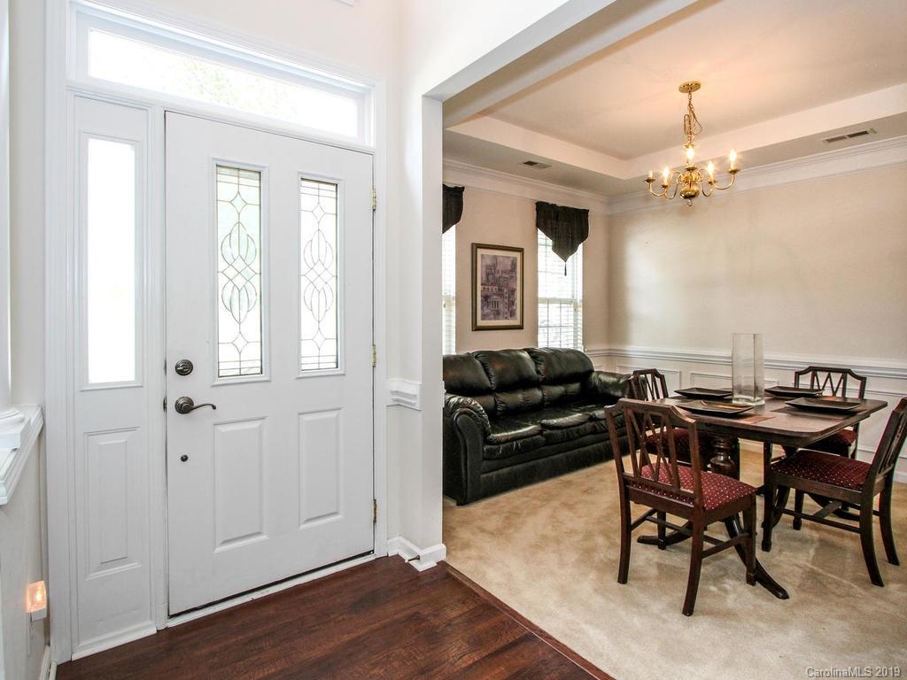 6924 Reedy Creek Road Charlotte, NC 28215 - Photo 4 of 47 a living room with furniture a chandelier and a window