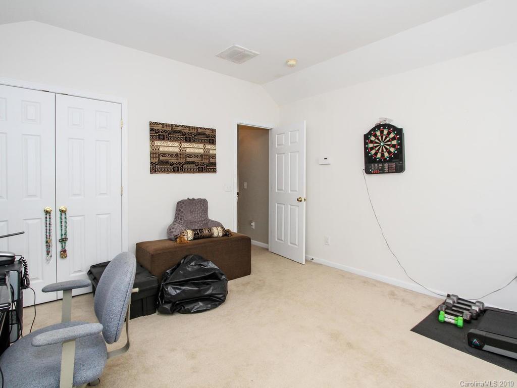 6924 Reedy Creek Road Charlotte, NC 28215 - Photo 31 of 47 a bedroom with a bed and a cabinets
