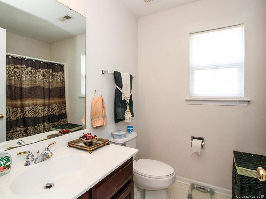 6924 Reedy Creek Road Charlotte, NC 28215 - Photo 32 of 47 a bathroom with a sink toilet vanity and tub