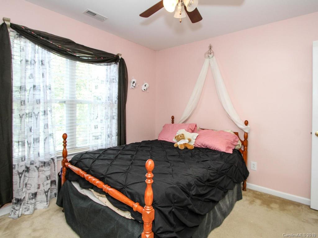 6924 Reedy Creek Road Charlotte, NC 28215 - Photo 34 of 47 a bed sitting in a bedroom next to a window