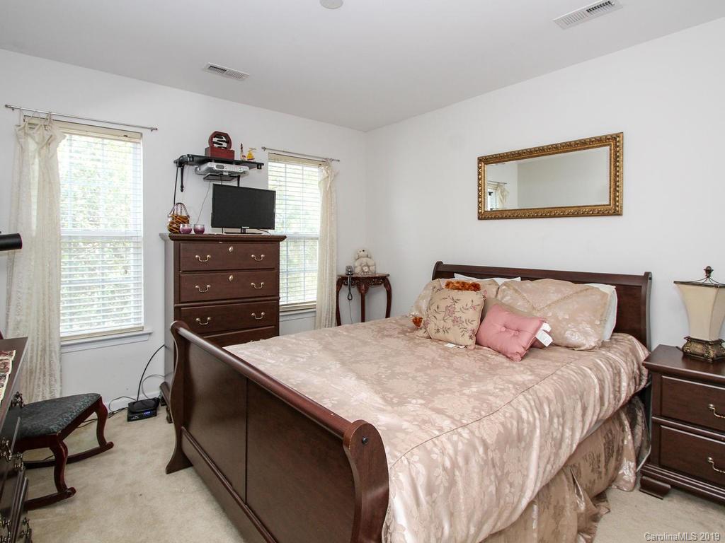6924 Reedy Creek Road Charlotte, NC 28215 - Photo 35 of 47 a bedroom with a bed and a flat screen tv
