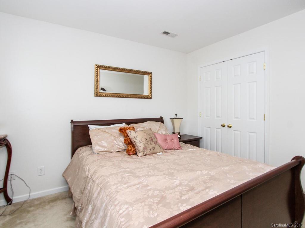 6924 Reedy Creek Road Charlotte, NC 28215 - Photo 36 of 47 a bedroom with a bed and painting on the wall