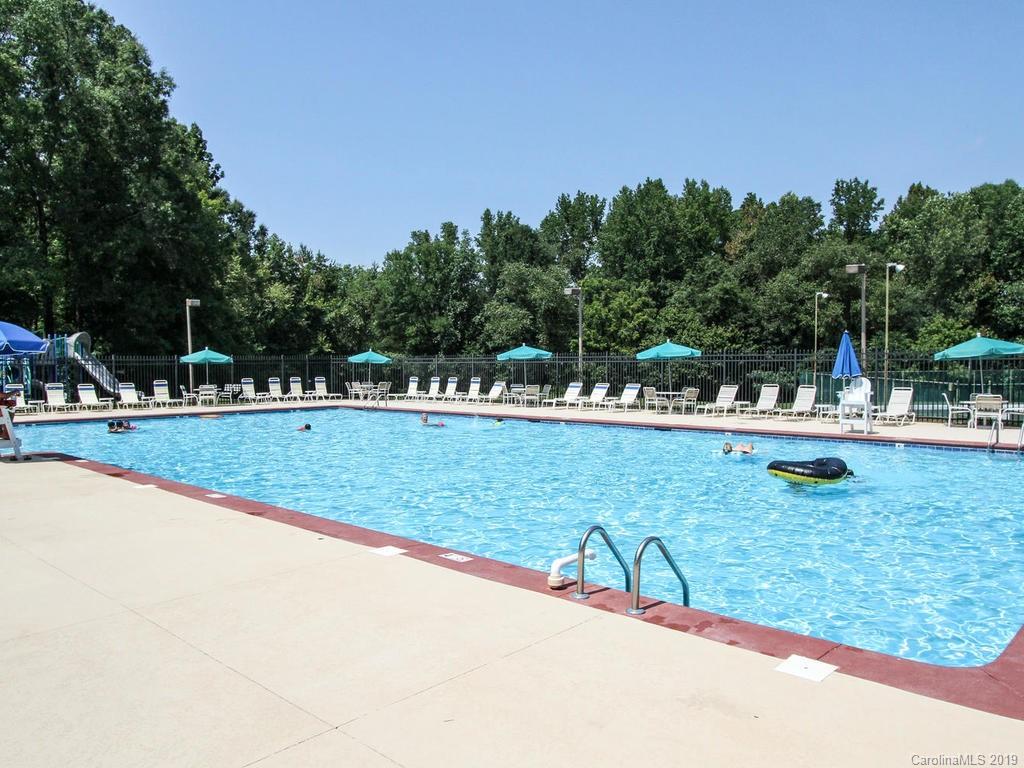 6924 Reedy Creek Road Charlotte, NC 28215 - Photo 46 of 47 a view of swimming pool with outdoor space and trees in the background