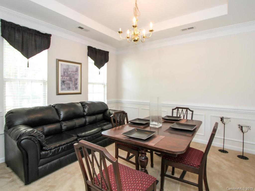 6924 Reedy Creek Road Charlotte, NC 28215 - Photo 6 of 47 a living room with furniture a table and a large window