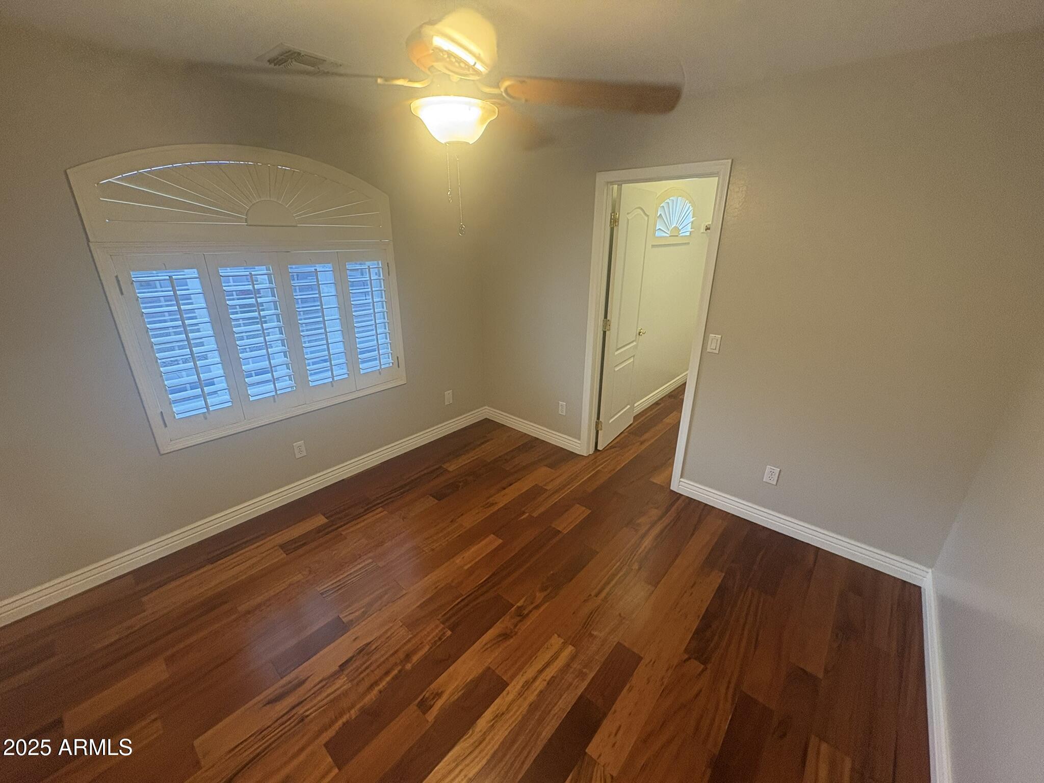 17633 North 41st Street Phoenix, AZ 85032 - Photo 14 of 24 an empty room with wooden floor and windows