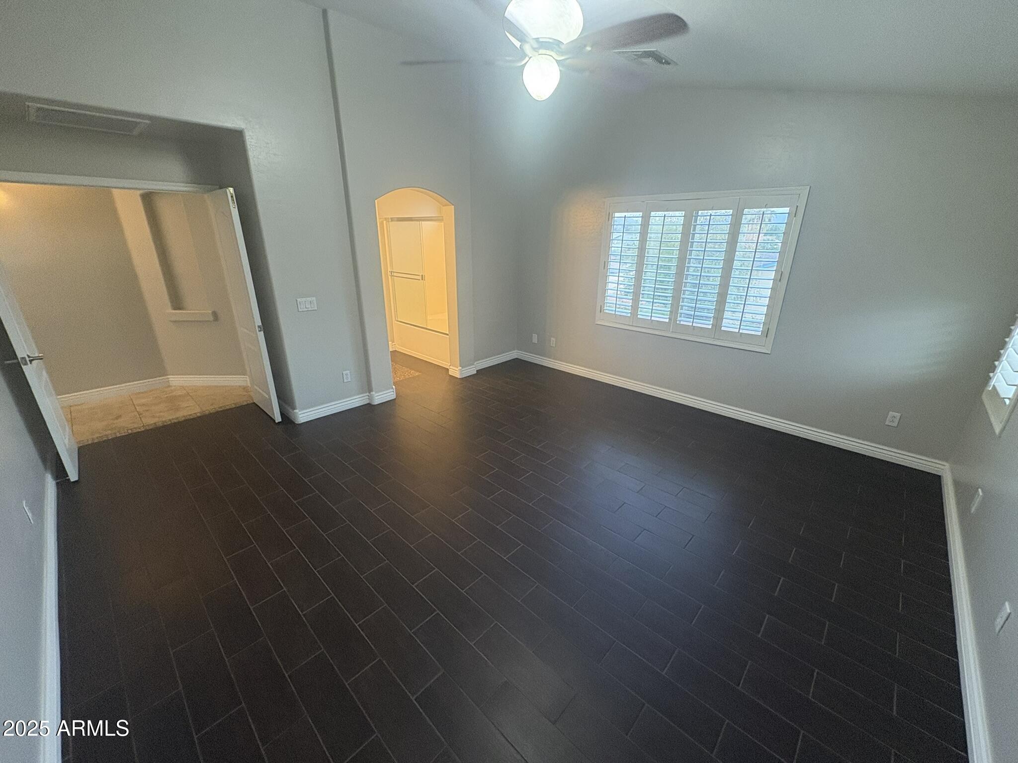 17633 North 41st Street Phoenix, AZ 85032 - Photo 19 of 24 an empty room with wooden floor and windows