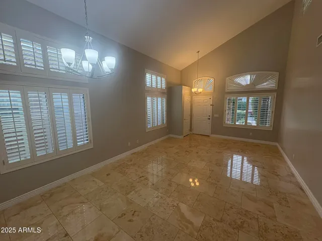 a view of an empty room with a fireplace and a window